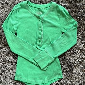 Green long sleeve henley with sparkly embellishment next to buttons. Size 5.